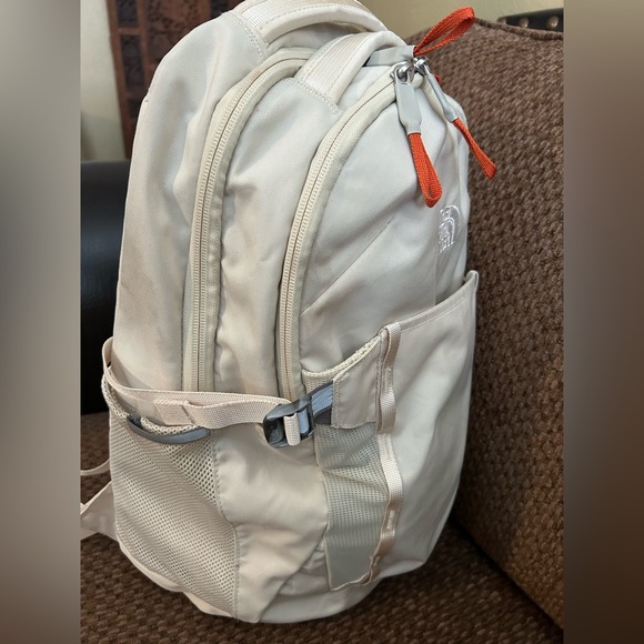 The North Face Handbags - The North Face Cream Backpack with Orange Zipper Pulls